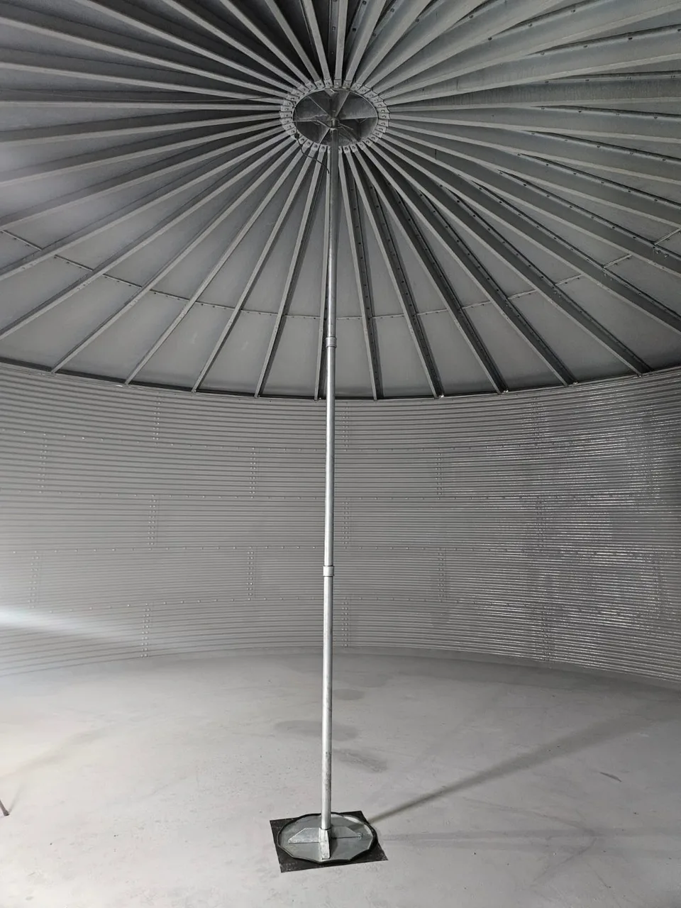 Internal view of a water storage tank showing the central roof support pole at Imjin Barracks